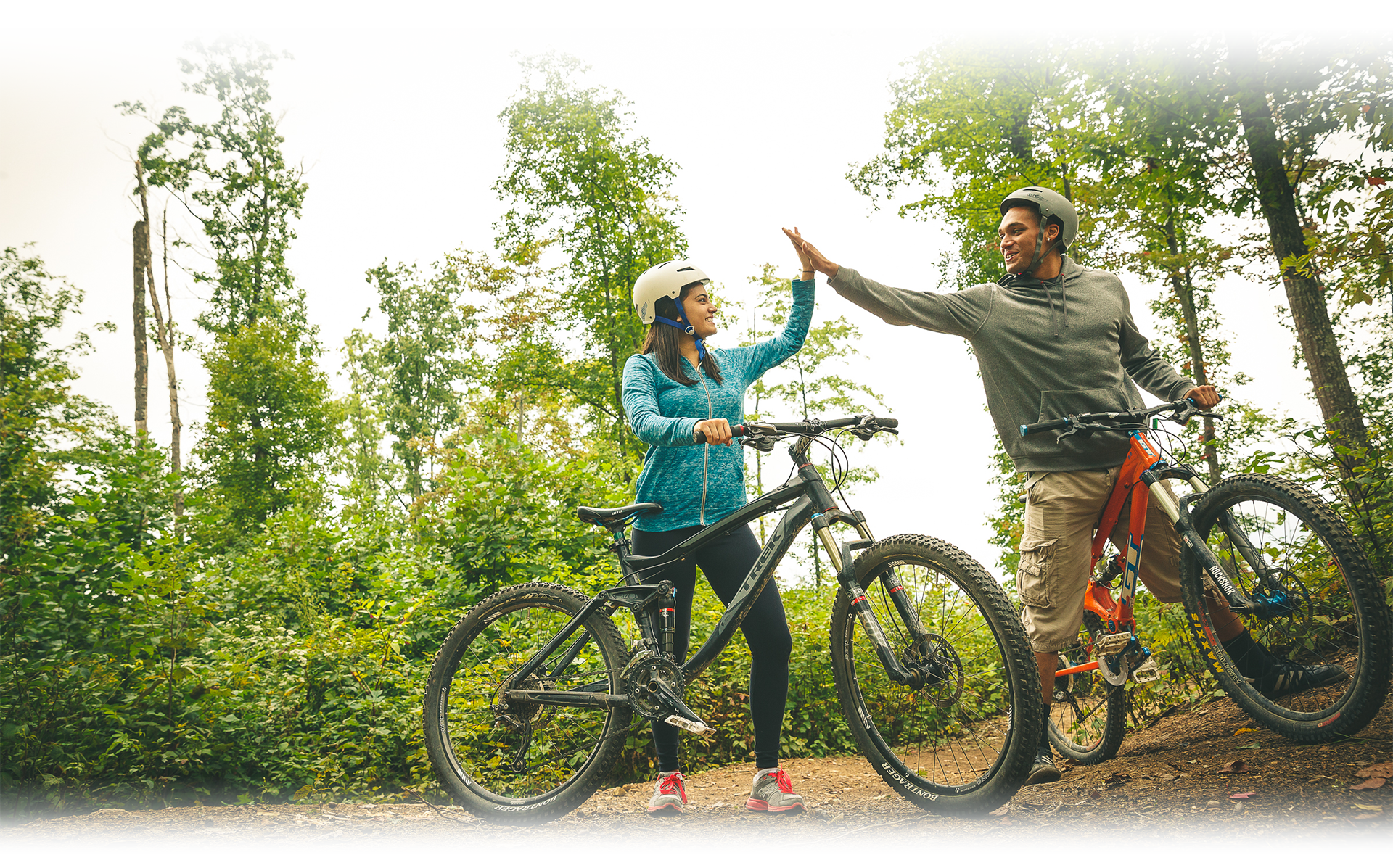 Two Scouts High Five on Bicycles