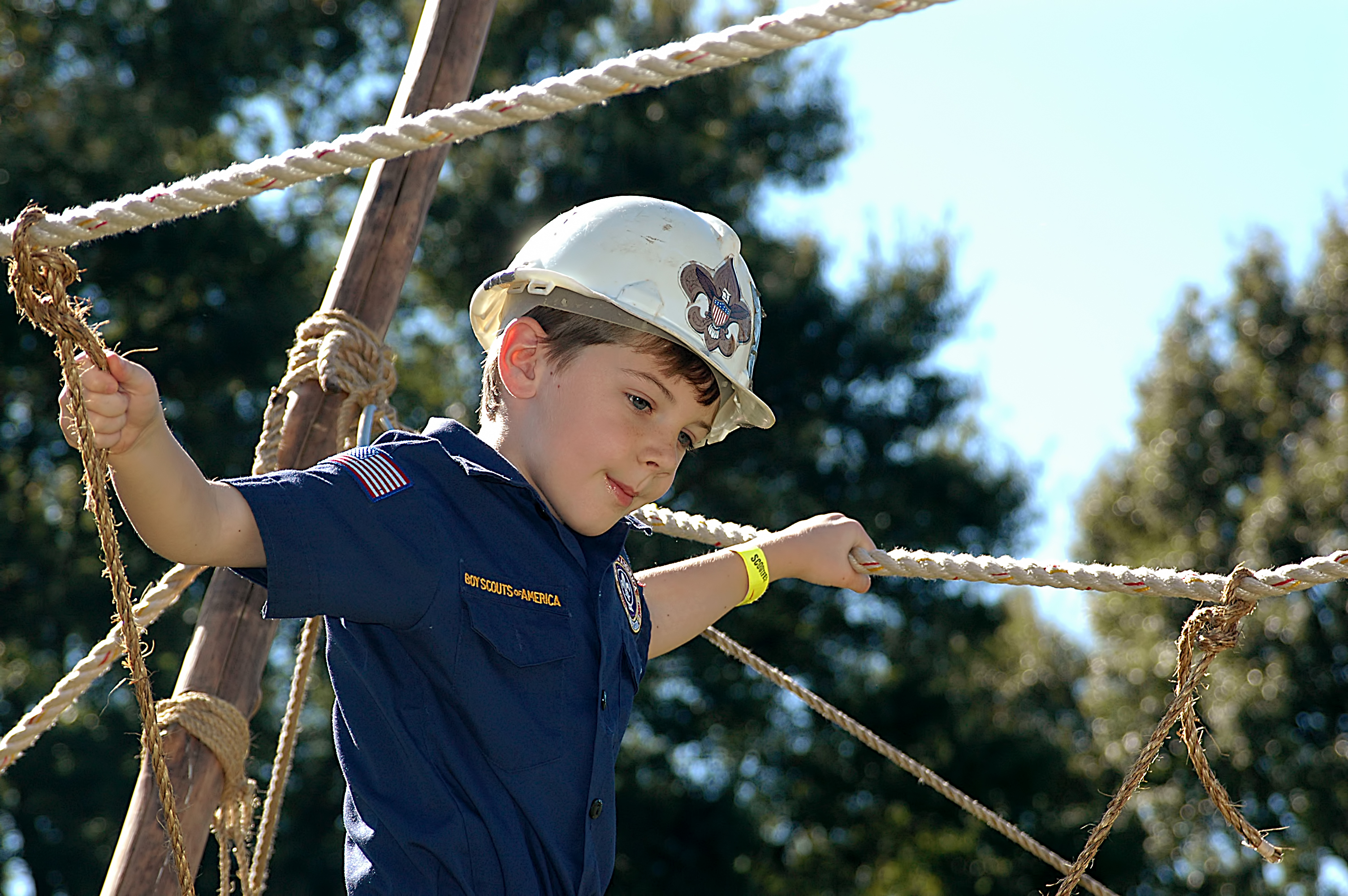 A Cub Scout crosses a bridge