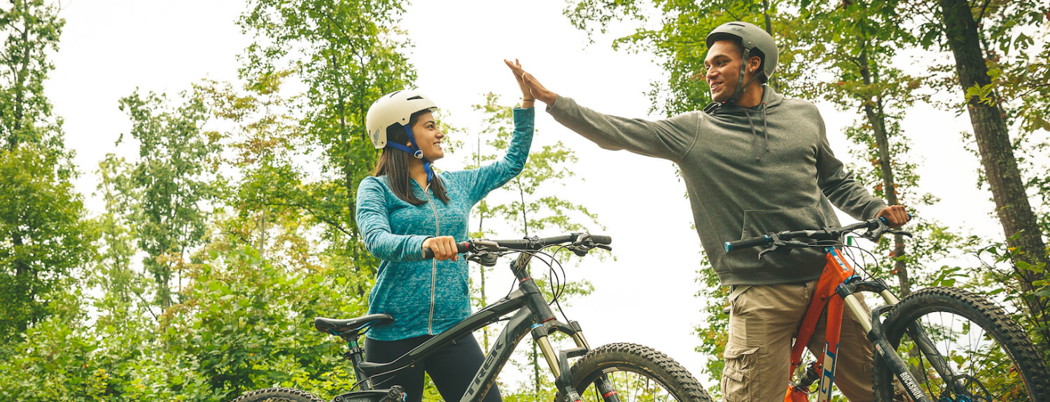 Venturers high-five on a biking trip